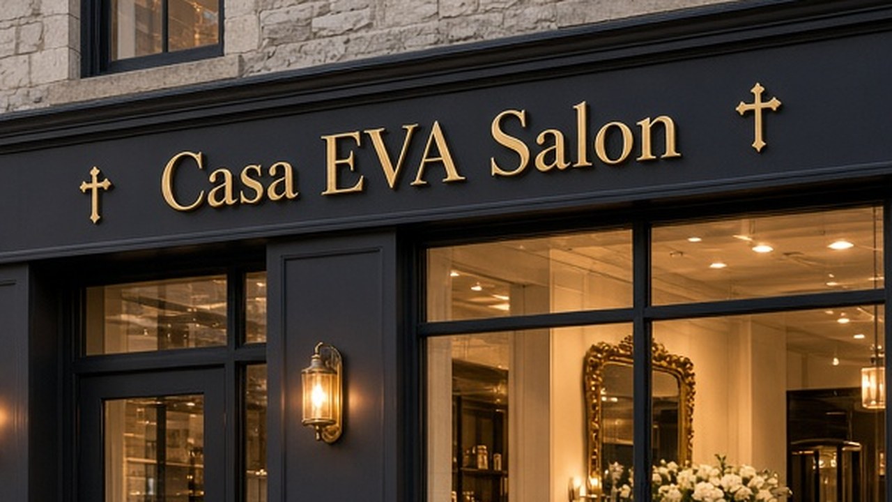 The gold Casa EVA Salon sign above the warmly lit windows of the Dubuque storefront